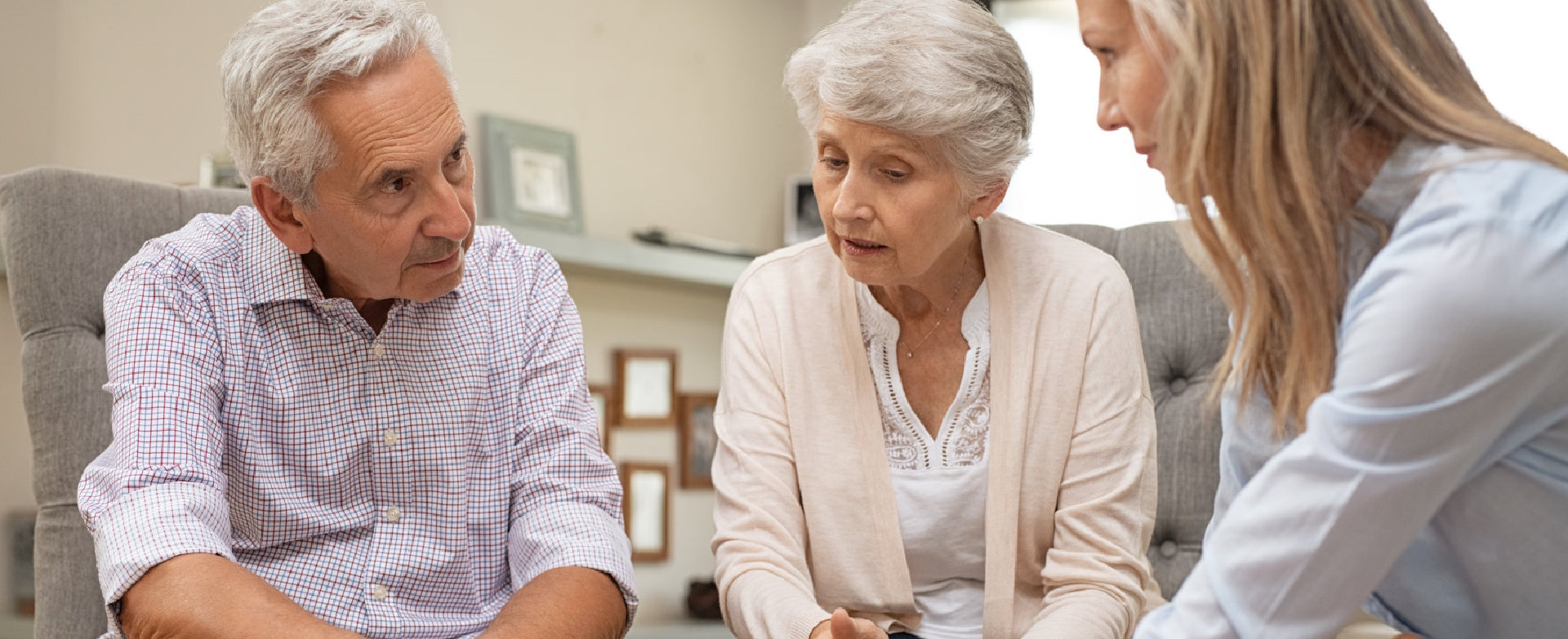 caregiver talking to a senior couple